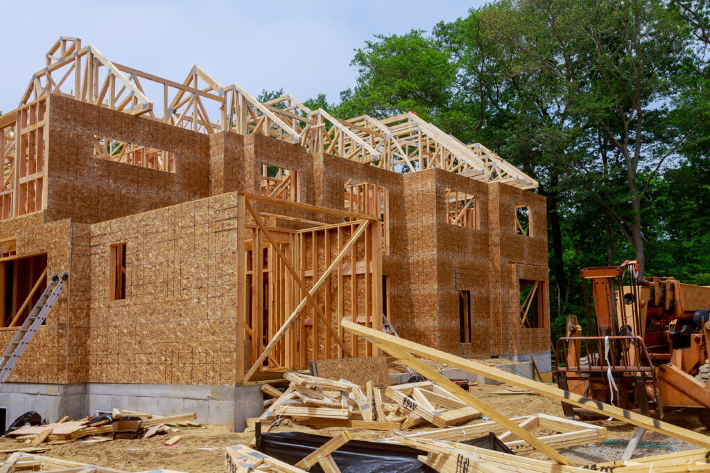 Boom truck forklift in the framing beam of new house under construction home