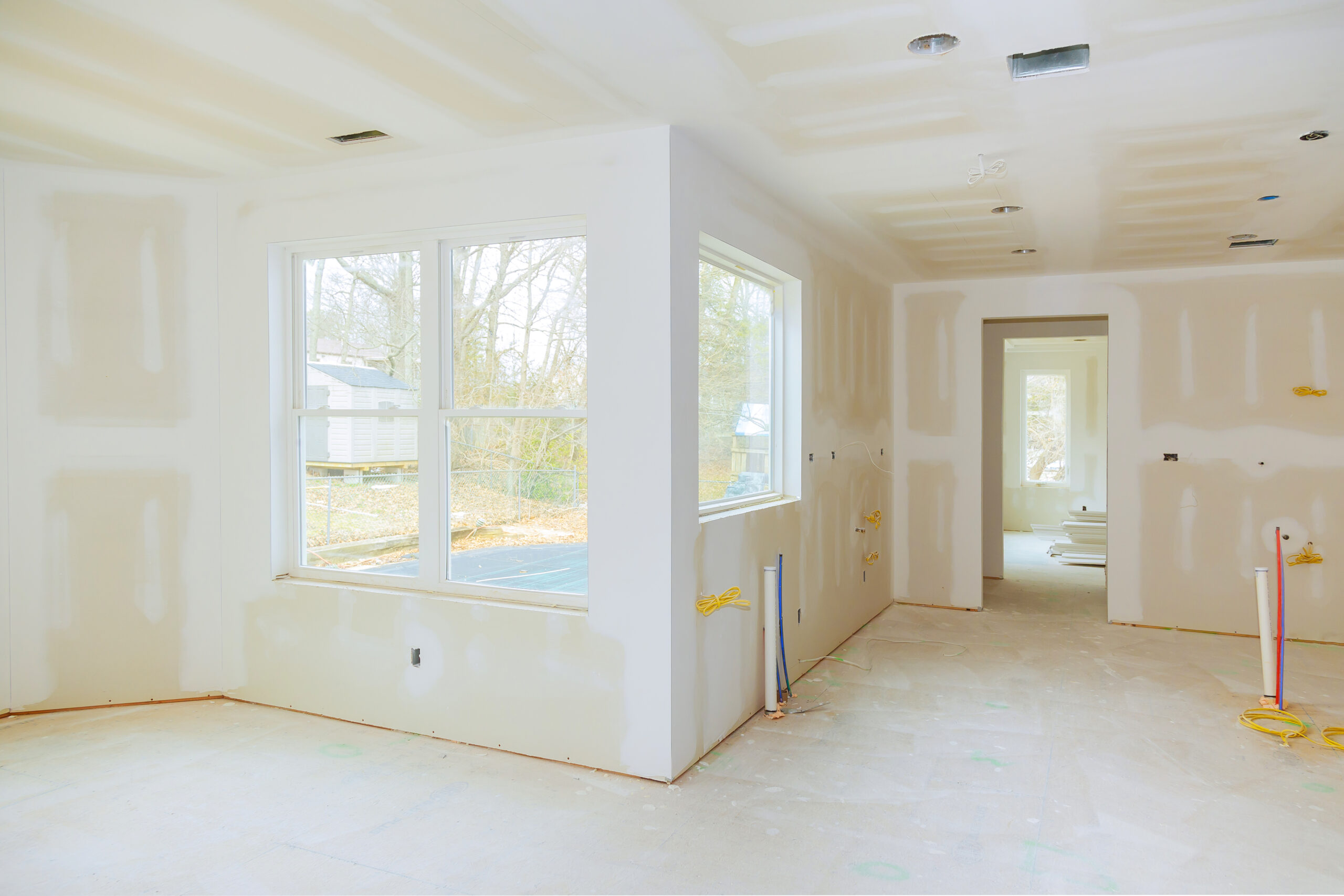 Interior construction of housing project with drywall installed and patched without painting applied